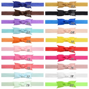 Detail view of 20 colors of ribbed grosgrain ribbon bows on high elasticity baby headbands