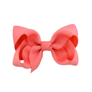 Vibrant coral pink grosgrain ribbon hair bow clip with multi-layered stacked design