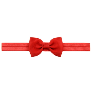 Detailed view of the red ribbed fabric texture on the baby bow headband elastic strap