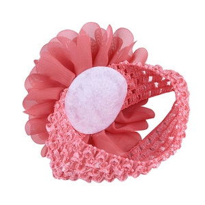 Elastic baby headband featuring a large coral pink chiffon flower for infants