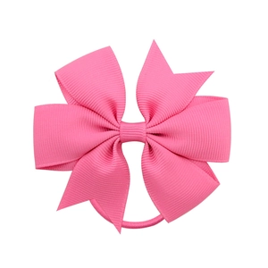 Pink ribbed grosgrain ribbon bow hair tie for girls with elastic band on white background