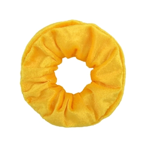 Vue macro montrant la texture douce du velours et les plis jaune vif du grand chouchou