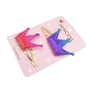 Glitter crown hair clips for kids with red and blue gradient sequins on card