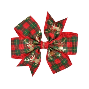 Christmas hair clip with red green tartan ribbon and golden reindeer prints