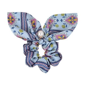 Detail of light blue bow scrunchie with bohemian floral print and large center pearl