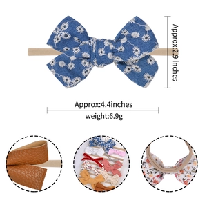 Detail showing baby bow headband with white daisy embroidery and nylon band dimensions
