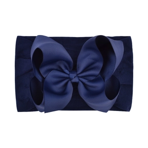 Detailed view of dark blue 6.3 inch oversized grosgrain bow on elastic nylon headband