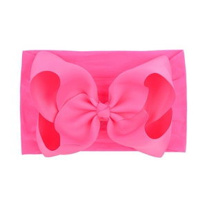 Detailed macro view of the 6.3 inch bright pink textured jacquard baby bow headband