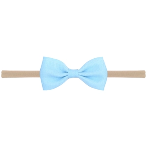 Macro detail of baby nylon headband with light blue grosgrain ribbon bow texture