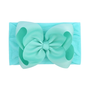Soft mint nylon elastic headband with a large textured grosgrain ribbon bow for infants