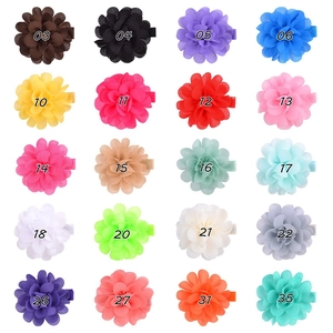 Flat lay of colorful chiffon flower hair clips in 20 assorted colors for girls