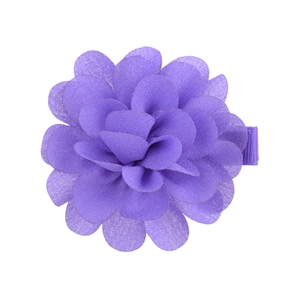 Detailed view of a handmade purple chiffon flower hair clip with a ribbon-wrapped edge