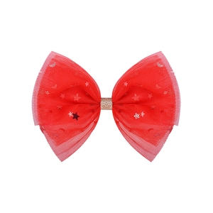 Macro detail of red mesh bow hair clip with silver stars and moons and golden glitter center