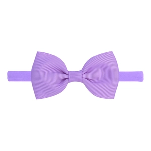 Detailed view of purple elastic nylon headband with high-density ribbed texture bow