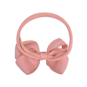 Elastic nylon baby headband with a soft pink ribbed fabric bow on a clean white background
