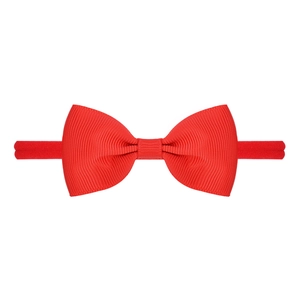 Detailed macro view of red grosgrain ribbon bow on soft elastic nylon baby headband