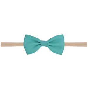 Detail of teal ribbed fabric bow and beige high-elastic seamless nylon baby headband
