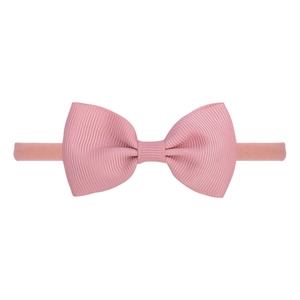 Detail of pink ribbed ribbon bow and soft stretch nylon headband for baby girls