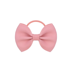 Close-up of pink grosgrain ribbon bow hair tie with detailed ribbed texture and elastic