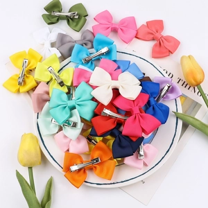 Close-up of colorful grosgrain ribbon bow hair clips with metal alligator clips