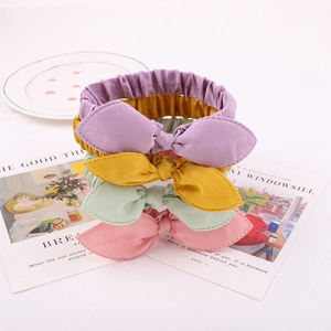 Knotted bunny ear elastic headbands set in purple, yellow, mint, and pink satin fabric