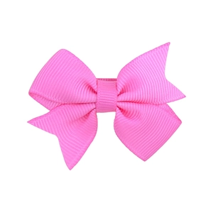 Detailed macro view of high-quality pink grosgrain ribbon bow with elegant texture