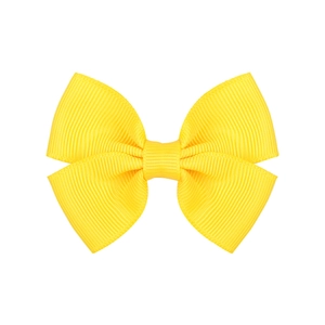 Detailed view of yellow grosgrain ribbon bow hair clip with textured ribbed fabric