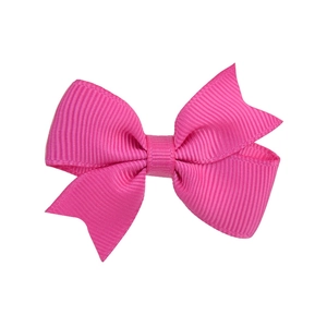 Detailed close-up of the pink grosgrain ribbon swallowtail hair bow with textured finish