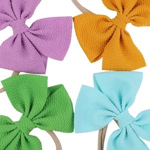 Detailed set of four colorful textured bow headbands with elastic nylon bands for babies