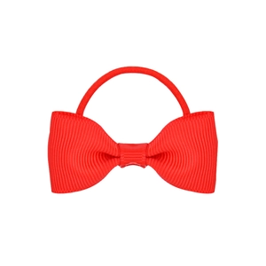 Detail of red grosgrain ribbon bow hair tie with textured weave and elastic band