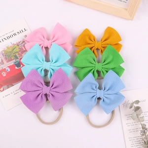 Detailed close-up of 6-pack baby headbands with waffle texture bows and soft nylon bands