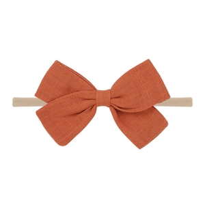 Rust red linen bow headband with soft nylon elastic band for newborn babies and infants