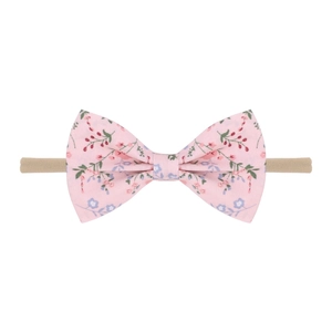 Détail du bandeau pour bébé avec nœud à motif floral rose et ruban élastique en nylon