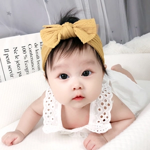 Baby girl nylon headband with large mustard yellow bow and soft jacquard texture