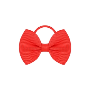 Detail of red grosgrain ribbon bow hair tie with durable elastic band and ribbed texture