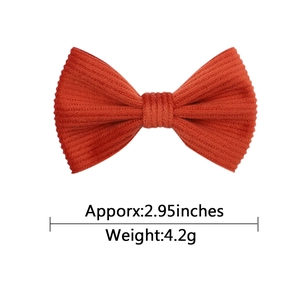 Corduroy bow hair clip for girls with soft floral pattern and orange red fabric texture