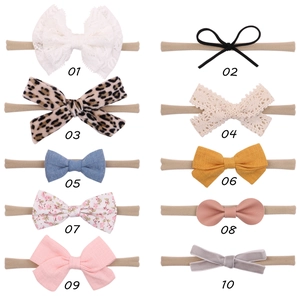 Set of 10 assorted baby headbands featuring lace, floral, and velvet fabric bows