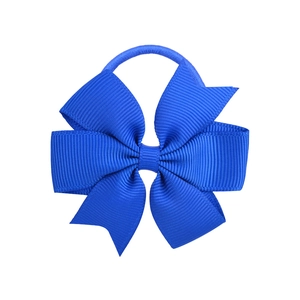Detail showing the grooved texture and layers of the royal blue grosgrain ribbon hair bow