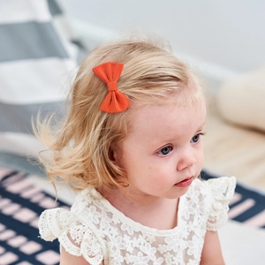 Classic orange corduroy bow hair clip for toddlers with textured ribbed fabric detail