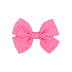Close-up detail of a pink grosgrain ribbon bow hair clip with textured ribbed fabric