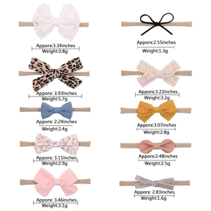 Close-up of baby headbands showing diverse textures like lace, floral, and velvet