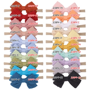 Detail view of colorful nylon baby headbands with textured jacquard bow variety