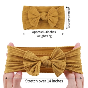 Mustard yellow nylon baby headband with jacquard bow showing size and stretch ability