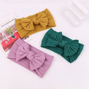Three-pack elastic nylon baby headbands with large bows in yellow, green, and purple