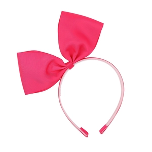 Détail du serre-tête nœud rose fuchsia avec dents antidérapantes pour coiffures de filles