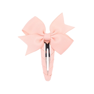 Detail of pink grosgrain ribbon bow hair clip with fully fabric-wrapped metal base