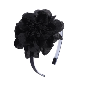 Détail montrant la fleur en mousseline noire multicouche sur un serre-tête élégant