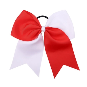 Detail of red and white two-tone grosgrain ribbon bow with black elastic hair tie