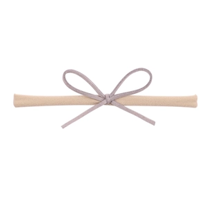 Detail of soft nylon baby headband featuring a dusty purple suede textured bow design