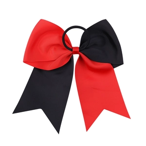 Close-up of dual-tone red and black grosgrain ribbon cheerleading bow with elastic band